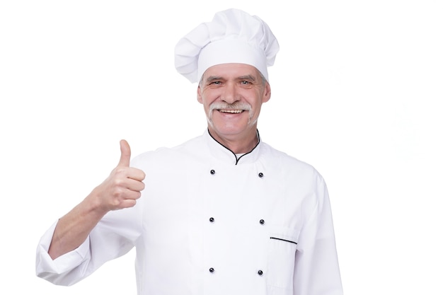 Free photo successful eldery chef with hand gesture