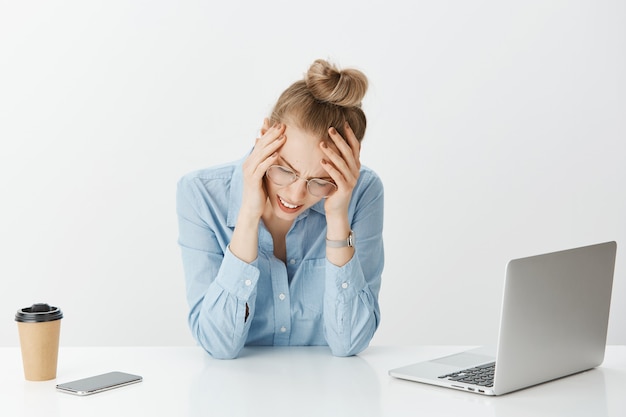 Free photo successful female entrepreneur in blue collar shirt