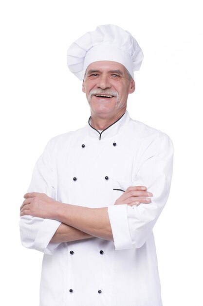 Successful and happy eldery chef crossed arms, portrait on white wall isolated