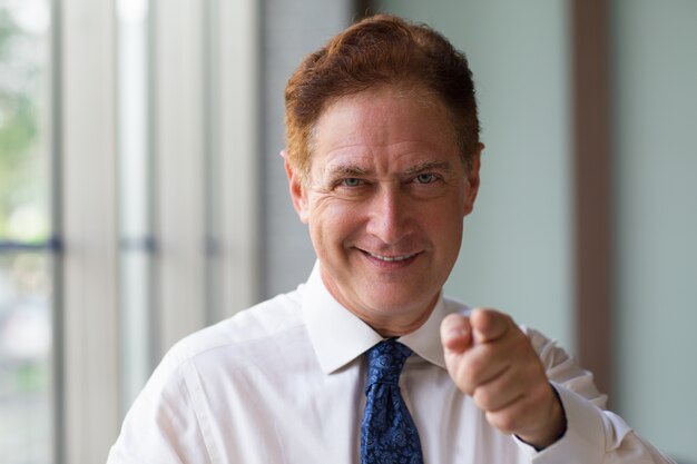 Successful man pointing to camera with finger