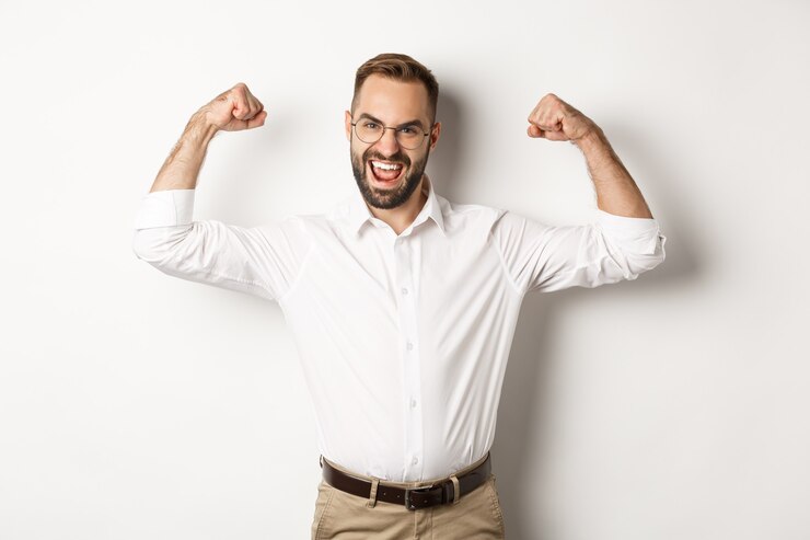 Free Photo successful manager flex biceps, showing muscles and looking confident, standing  .
