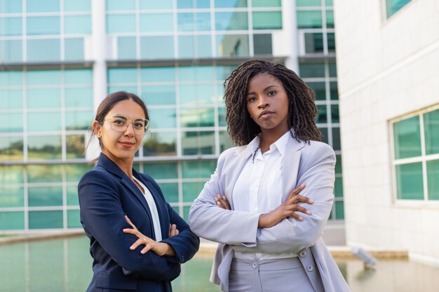 Successful mix raced businesswomen posing with hands crossed