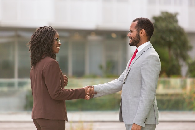 Successful multiethnic businesspeople greeting each other