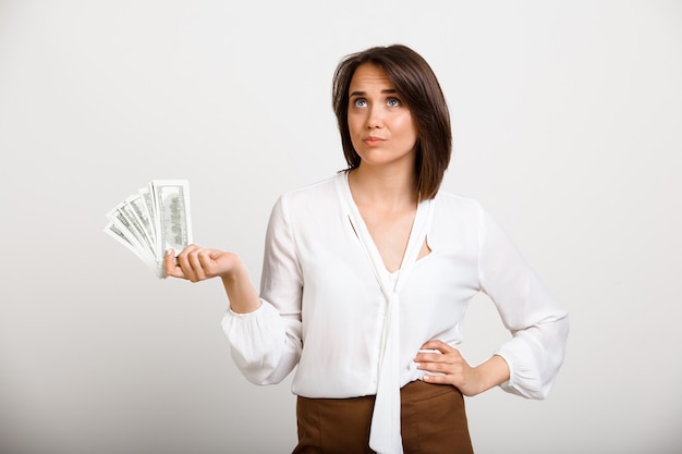 Free photo successful rich fashion woman holding money