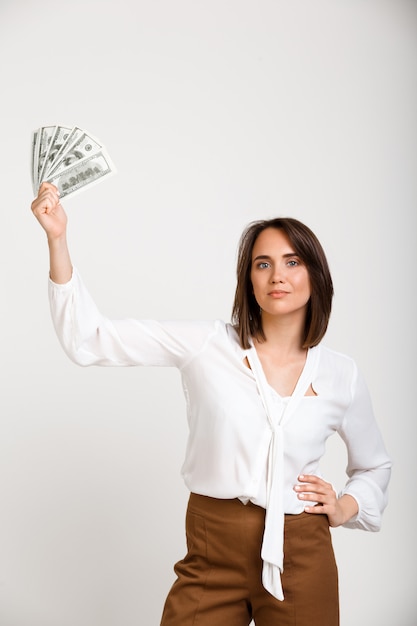 Free photo successful rich fashion woman showing money