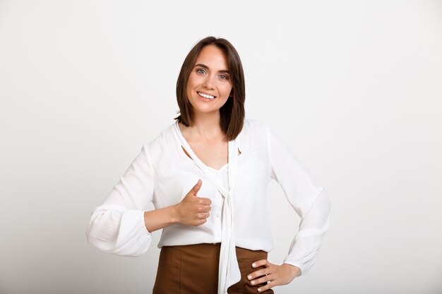 Successful satisfied fashion woman thumbs-up