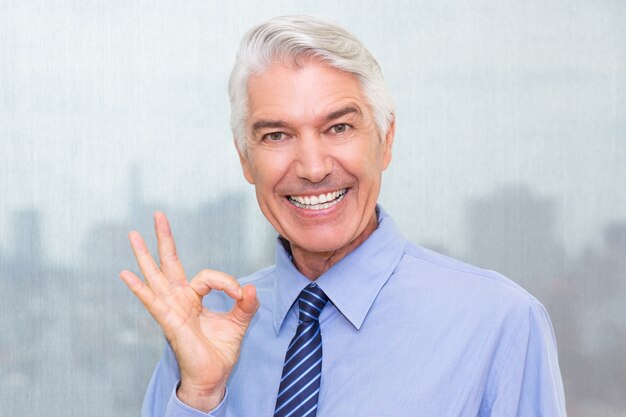 Successful senior businessman showing ok sign