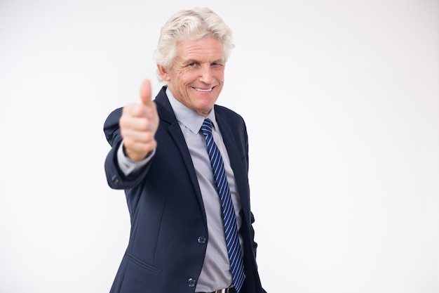 Free photo successful senior businessman showing thumbs up