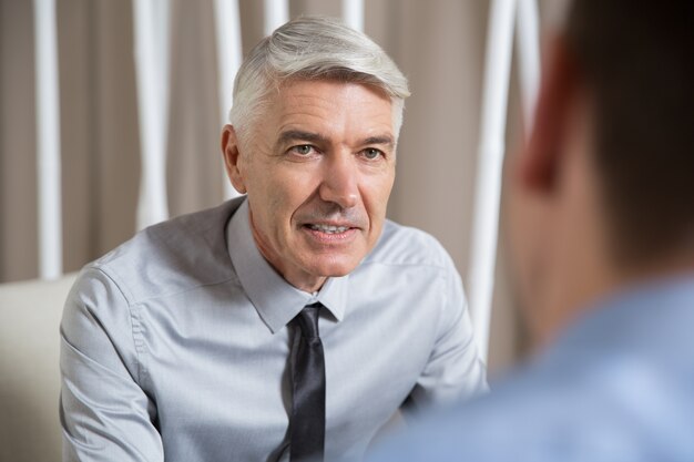 Successful Senior Businessman Talking to Partner