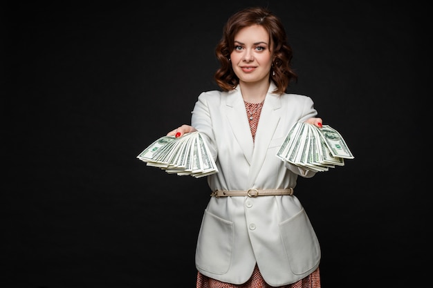 Successful stylish brunette model with money in hands.