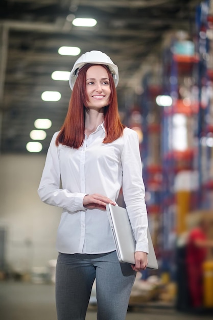 Successful woman with laptop smiling looking to side