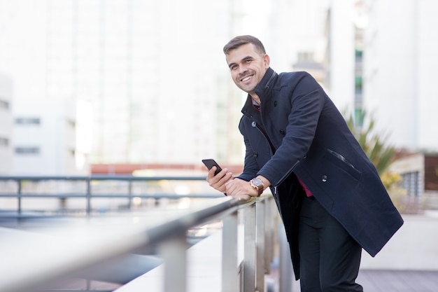 Successful young businessman standing on rooftop