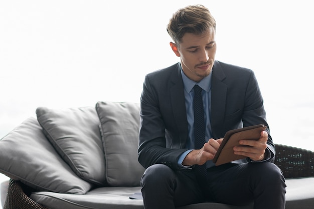 Successful Young Businessman Using Tablet Computer