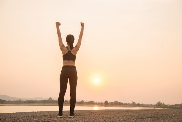 Free photo successful young woman runner warming up