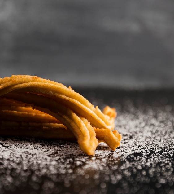 Sugar and churros on a table close-up