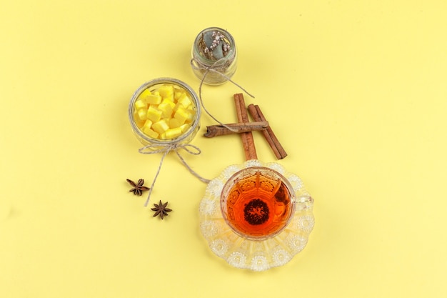 Sugar cubes, spices, dried herbs, and tea in a glass cup