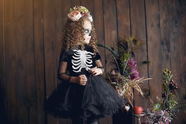 Sugar Skull little girl Halloween costume and makeup. Halloween party. Day of The Dead.