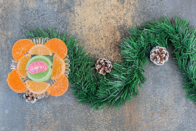 Sugary fruit jelly candies with pinecones and bunch of Christmas tree. High quality photo