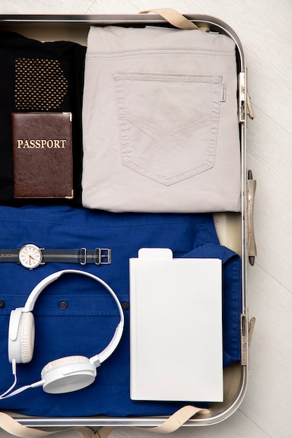 Free photo suitcase packed with travel paraphernalia