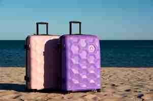 Free photo suitcase with wheels on beach