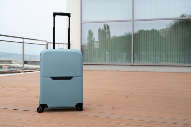 Free photo suitcase with wheels outdoors