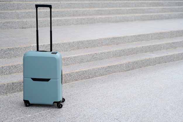 Free photo suitcase with wheels outdoors