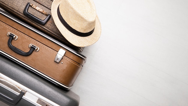 Free photo suitcases for travel with straw hat