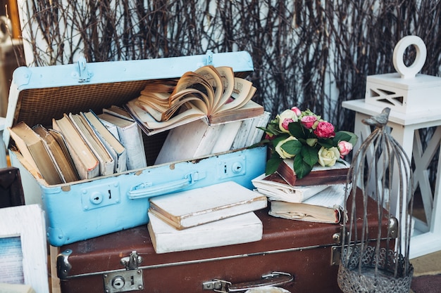 Suitcases with books and flowers on the table
