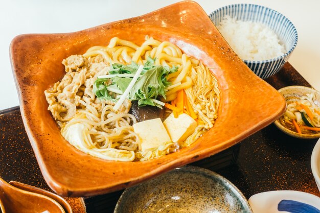 Suki noodles in hot plate with rice