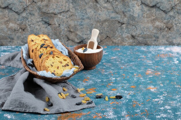 Sultana pie slices in a wooden tray on a blue towel