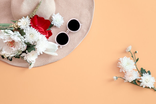 Free photo summer background with flowers and a hat.