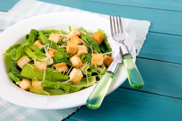 Summer caesar salad on wooden table