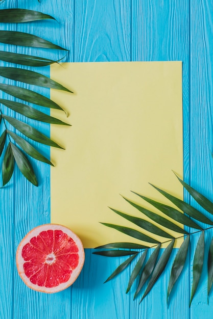 Summer composition with blank paper and grapefruit