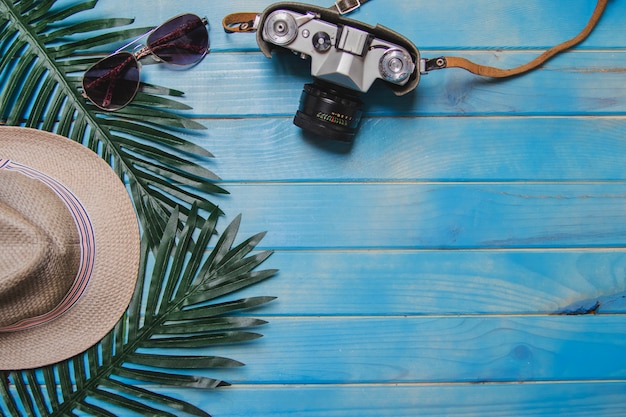 Summer composition with decorative elements on blue wooden surface