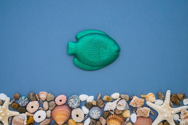 Free photo summer composition with green fish and decorative items