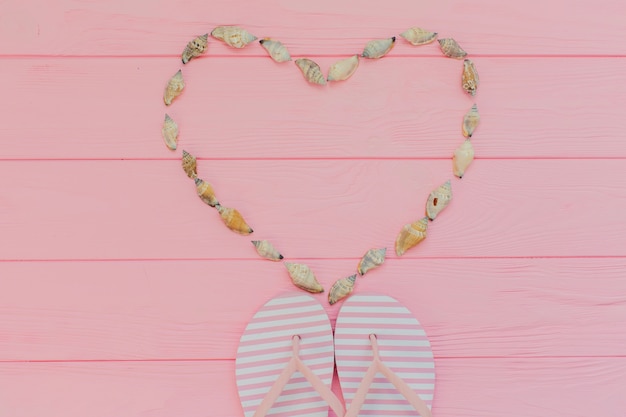 Summer composition with seashells forming a heart