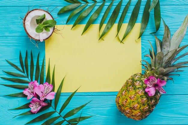 Summer composition with yellow paper and fruits