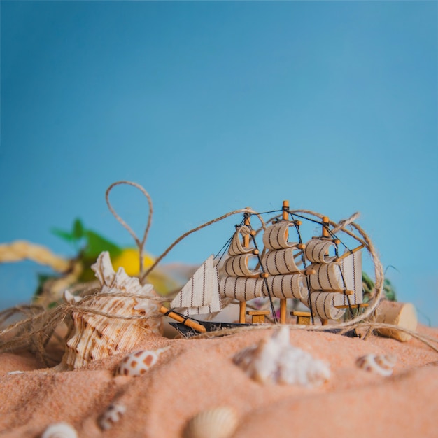 Summer concept with sailing boat and seashells