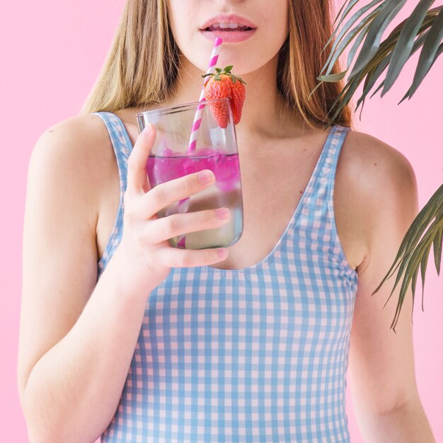 Summer concept with woman drinking cocktail