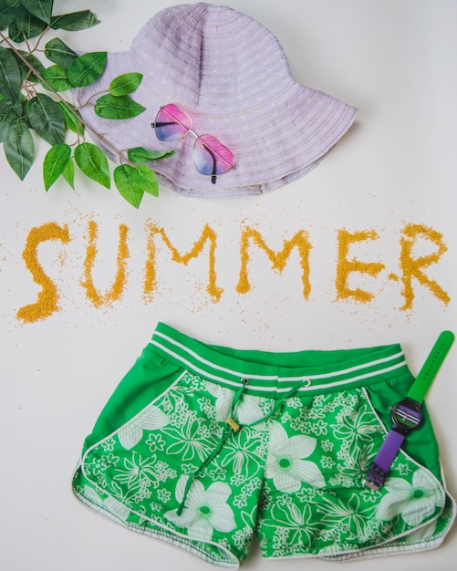Summer decoration with shorts, hat and leaves