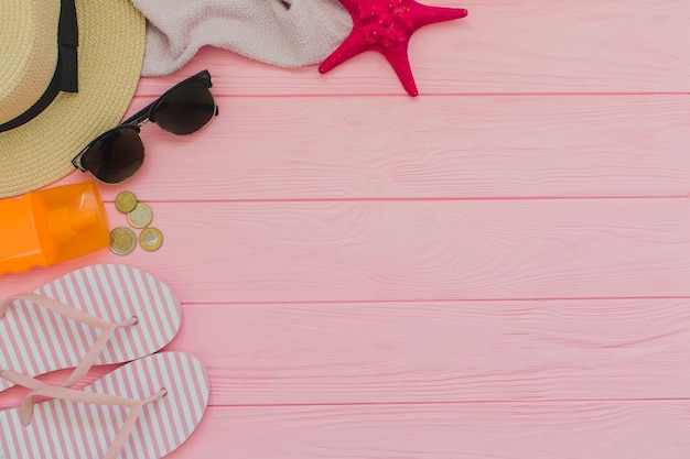 Summer elements on pink wooden surface