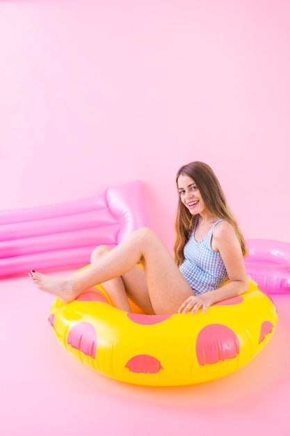 Summer fashion concept with woman sitting in inflatable ring
