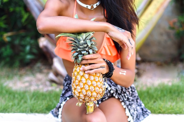 Summer image ow woman holding pineapple, tropical style.