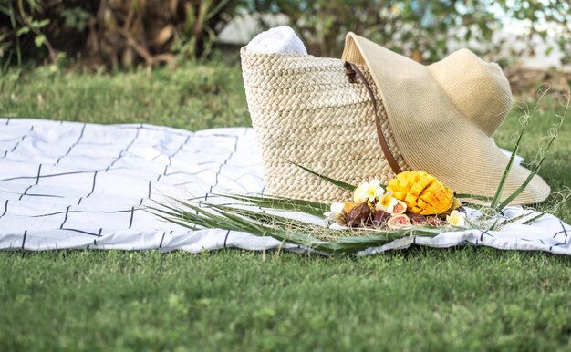 Summer picnic with a plate of tropical fruits.