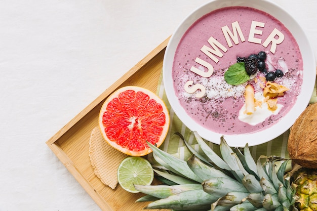 Summer smoothie in bowl and grapefruit