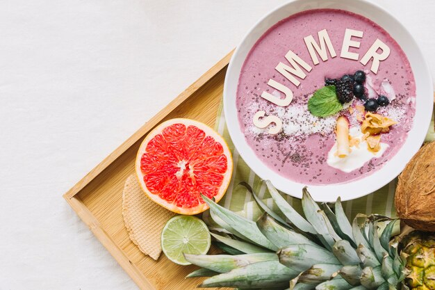 Summer smoothie in bowl and grapefruit
