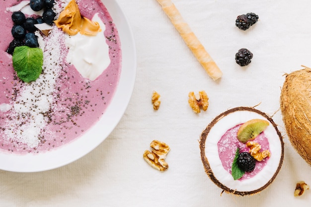 Summer smoothie in coconut and bowl