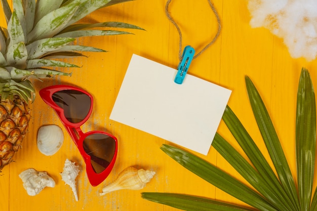 Summer  with shells, glasses, fruit and paper On a yellow 