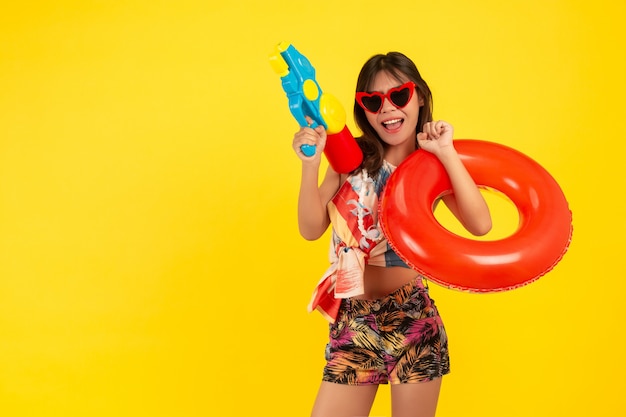 summer young beautiful woman with water gun and Rubber band, songkran holidays