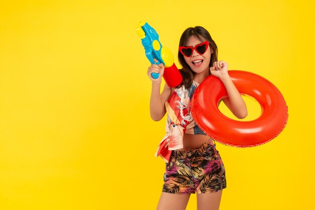 summer young beautiful woman with water gun and Rubber band, songkran holidays